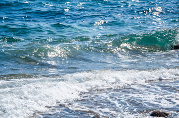 Naklejka na ściany i meble Seascape background white waves on blue sea