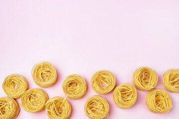 Group of Italian Egg Pasta Nest Tagliatelle Pink Background Italian Food Top View Copy Space
