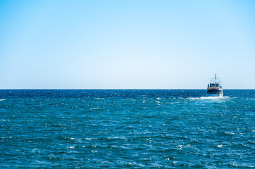 Seascape ship sailing on blue sea background