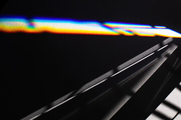 Black futuristic shadows and bright light refraction glow effect with colorful rainbow. Black noir...