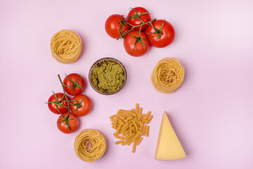 Dry Raw PastaTagliatelle Pesto Parmesan Cheese Raw Tomato Top View Pink Background Top View