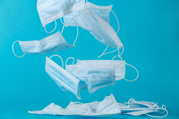 throw away surgical masks falling in the air