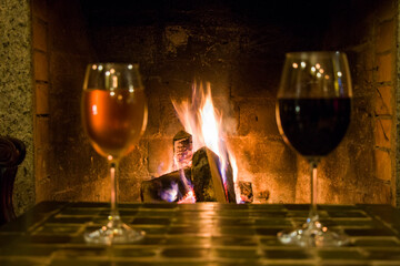 Full wine glass on the table and fireplace background