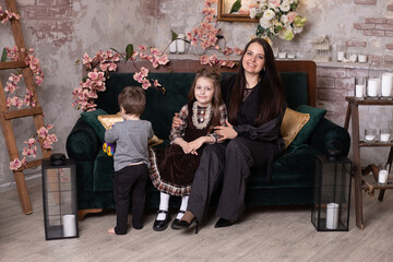 happy family on sofa at home, mother and her son and daughter
