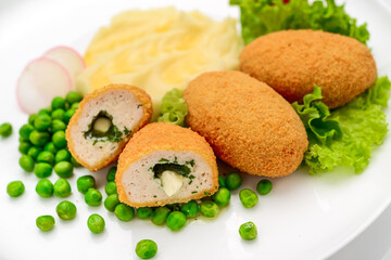 Chicken cutlets in bread crumbs stuffed with butter and herbs