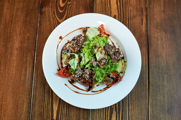 A plate of food sitting on top of a wooden table