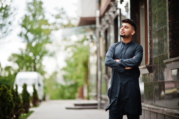 Сonfident pakistani indian muslim arabic boy in grey kameez shalwar suit.