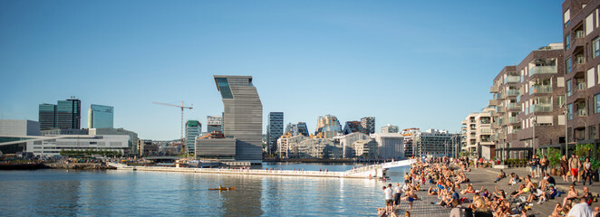 Panorama view on Oslo downtown. Sunny summer day, people enjoying sun, view on Oslo Opera House, sea and new Munch museum. - obrazy, fototapety, plakaty