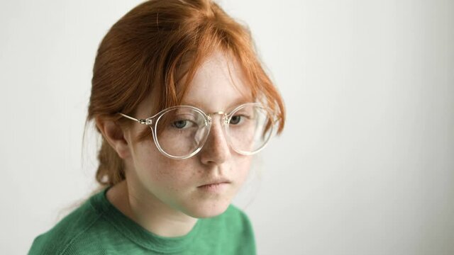 Upset red-haired girl in eyeglasses afraid of ophthalmologist visit, healthcare