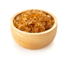 Brown rock sugars in bowl on white background