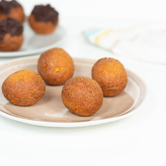 Deep fried bunuelos balls. Creative minimalist composition on a white background.