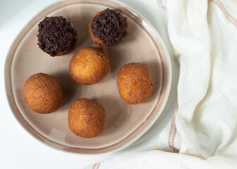 Deep fried bunuelos balls. Creative minimalist composition on a white background.