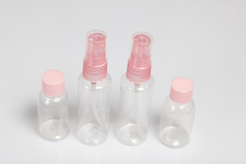 Plastic bottles for cosmetics with a spray. On white background.