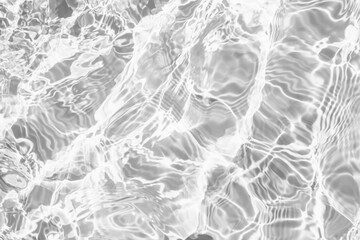 Closeup of desaturated transparent clear rough water surface texture with splashes and bubbles....
