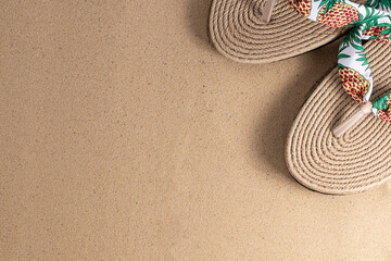 Summer vacation concept. Hat and flip flops on sand background with a copy of space. Summer...