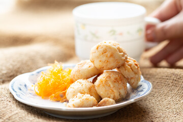 Golden cookies balls with eggs silk for tea time in morning in white plate
