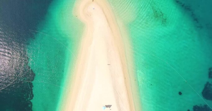A bird's-eye-view shows tourists swimming at Zlatni Rat Beach on Brac Island, Croatia.
