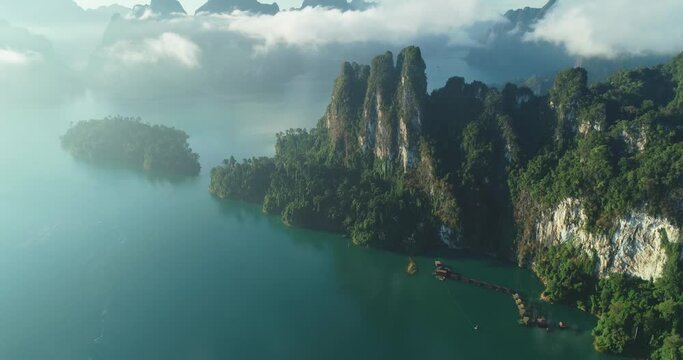 An aerial view shows green mountains and harbor lodgings among the clouds at Khao Sok National Park in Surat Thani, Thailand.