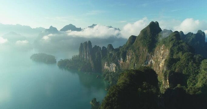 An aerial view shows green mountain islands of Khao Sok National Park in Surat Thani, Thailand among clouds.