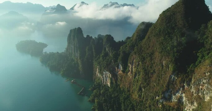 An aerial view shows green mountains and harbor lodgings among the clouds at Khao Sok National Park in Surat Thani, Thailand.