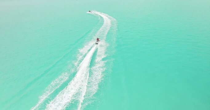 Tourists go jet-skiing in Maldives.
