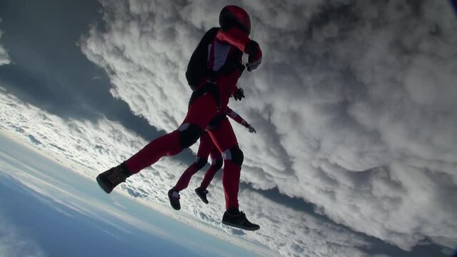 Two sports parachutist build a figure in free fall. Extreme sport concept.
