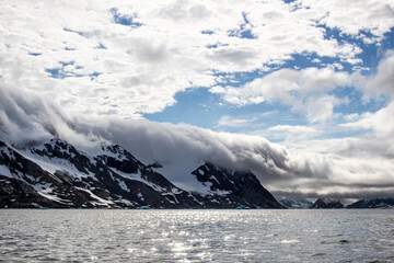 Clouds rolling over Mountain tops in Svalbard