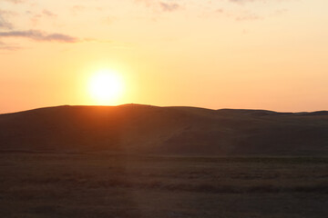 Hilly plain in the evening at sunset.