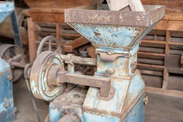 Blue rice paddy mill machine to make white rice grain That has been used for a long time until rusting in the rice mill