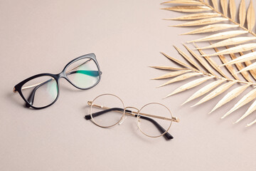 Stylish eyeglasses over pastel  background. Optical store, glasses selection, eye test, vision...