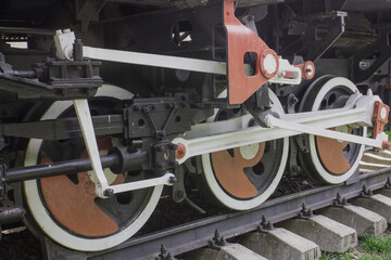 Wheels of an old steam locomotive. An old steam locomotive. Red locomotive wheels.