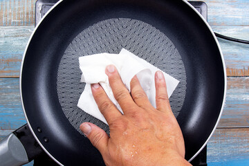 chef wiping the pan before cooking
