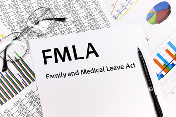 FMLA family medical leave act Concept. the inscription on the sheet. pen, glasses, documents,...