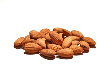 pile of organic peeled brown almonds isolated on the white background full depth of field concept of vegan raw ingredient for vegetarian snack and healthy food