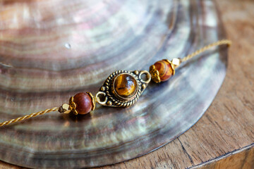 Elegant tiny bracelet with crystal gemstone tiger eye on waxed string