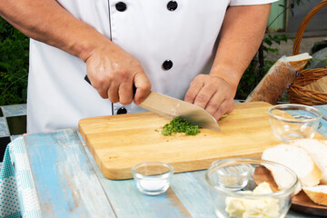 Chef  chopped parsley for cook garlic bread