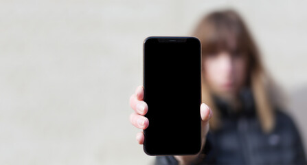 Woman holds smartphone at camera, selective focus instagram social media communication range lifestyle technology success