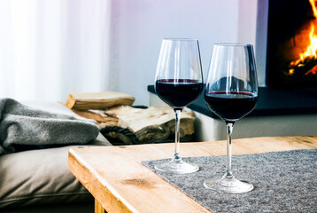 close-up of two glasses with red wine on table in living room