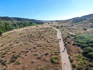 Aerial view of Los Penasquitos Canyon Preserve with tourists, hikers and bikers on the trails,....