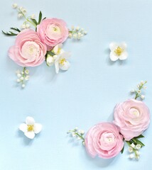 Floral background delicate. of pink Ranunculus and lily of the valley on a blue background. Romantic background for wedding invitations and greeting cards. place for text. copy space. Flatlay.
