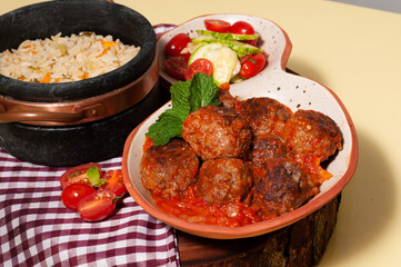 delicious meatballs with tomato sauce and salad