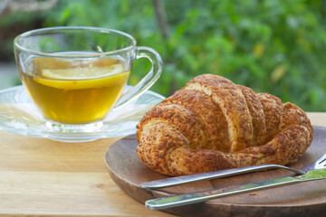 Hot Tea with croissant bread on  Wooden Bar