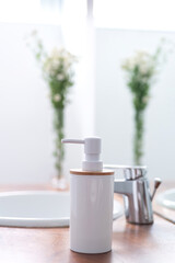 Soap dispenser in a modern bright bathroom