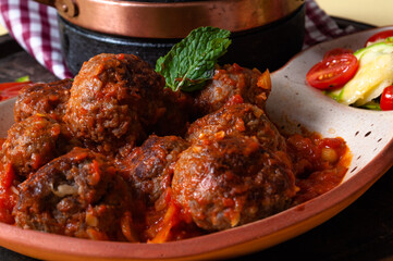 delicious meatballs with tomato sauce and salad