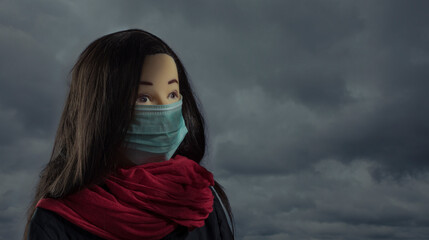 Close up portrait of human face covered with mask on sky back