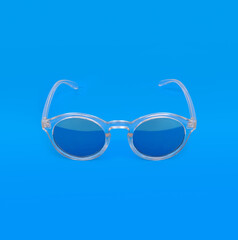 Fototapeta premium Sunglasses isolated on blue background for applying on a portrait