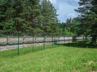 Fototapeta na wymiar Fence with barbed wire defending
