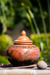 Thai pottery jar is a container for water. With a water scoop beside Popular decorating in the house