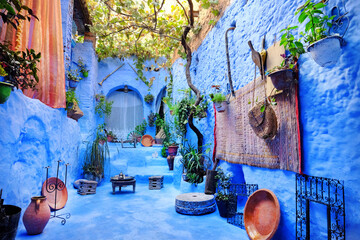 Cozy patio inside a blue house in medina of the blue city Chefchaouen, Morocco. Traditional moroccan architectural details.