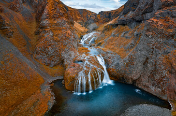 View from flying drone of Stjornarfoss waterfall at midnight sun. Splendi autumn scene of Iceland,...
